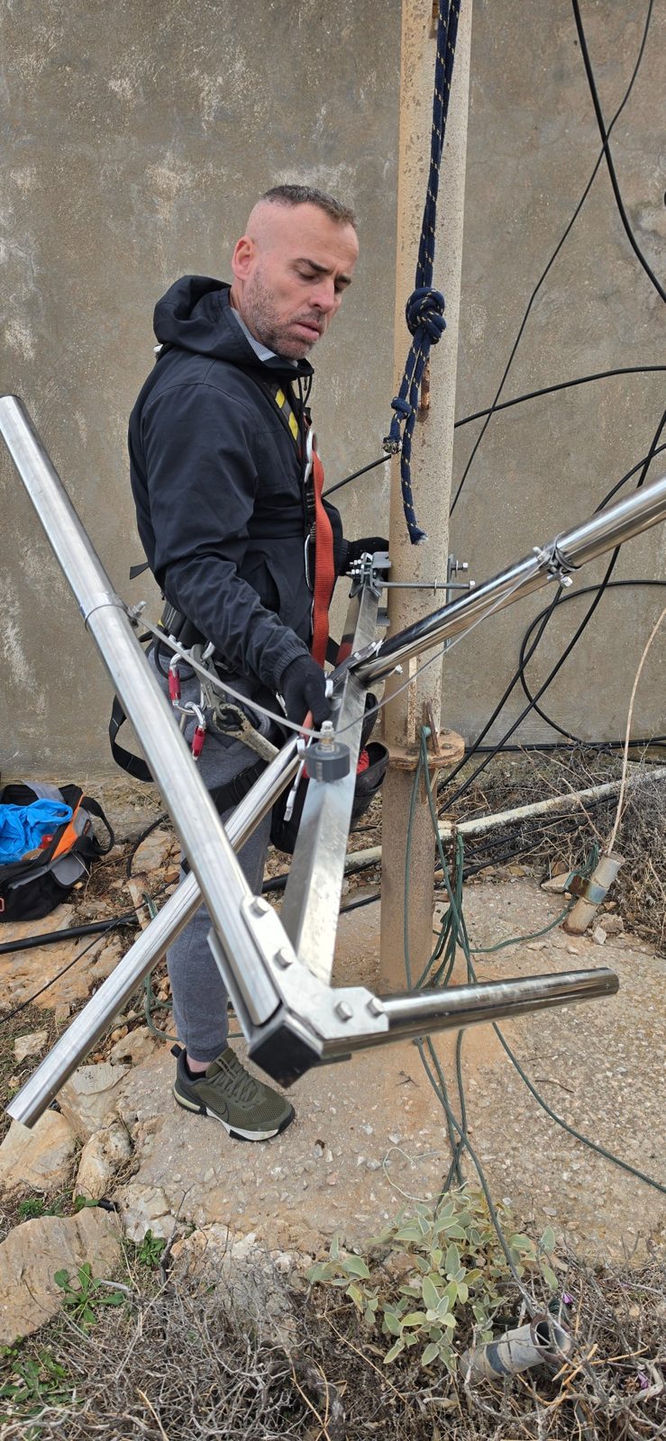 Technician assembling a new circularly polarized FM antenna at the base of the RadioActive 91.3 FM mast in Artemonas, Sifnos