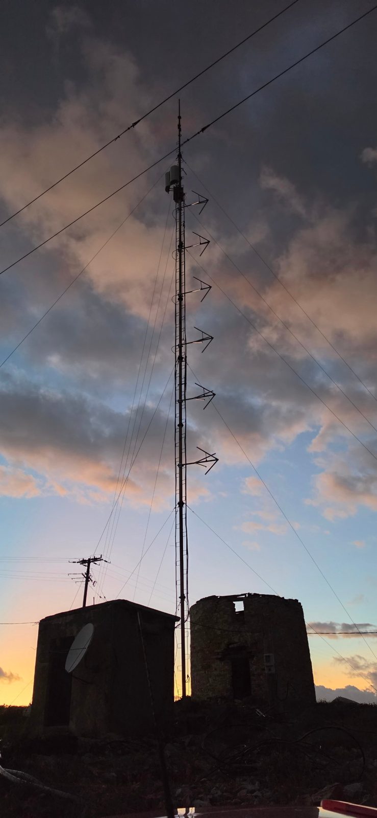 Silhouette of the RadioActive 91.3 FM mast with its new antennas at sunset over Sifnos in the Cyclades